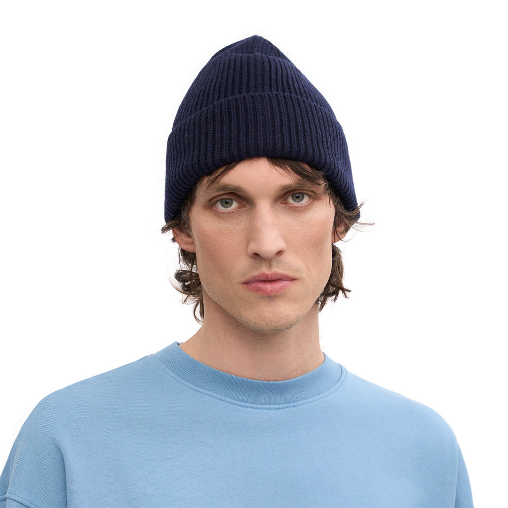 Colorful Standard Merino Wool Beanie Navy Blue – worn by a male model, front view
