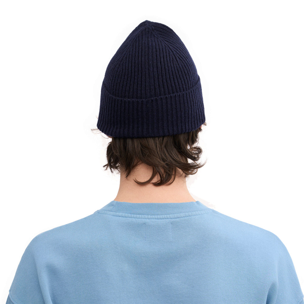 Colorful Standard Merino Wool Beanie Navy Blue – worn by a male model, back view