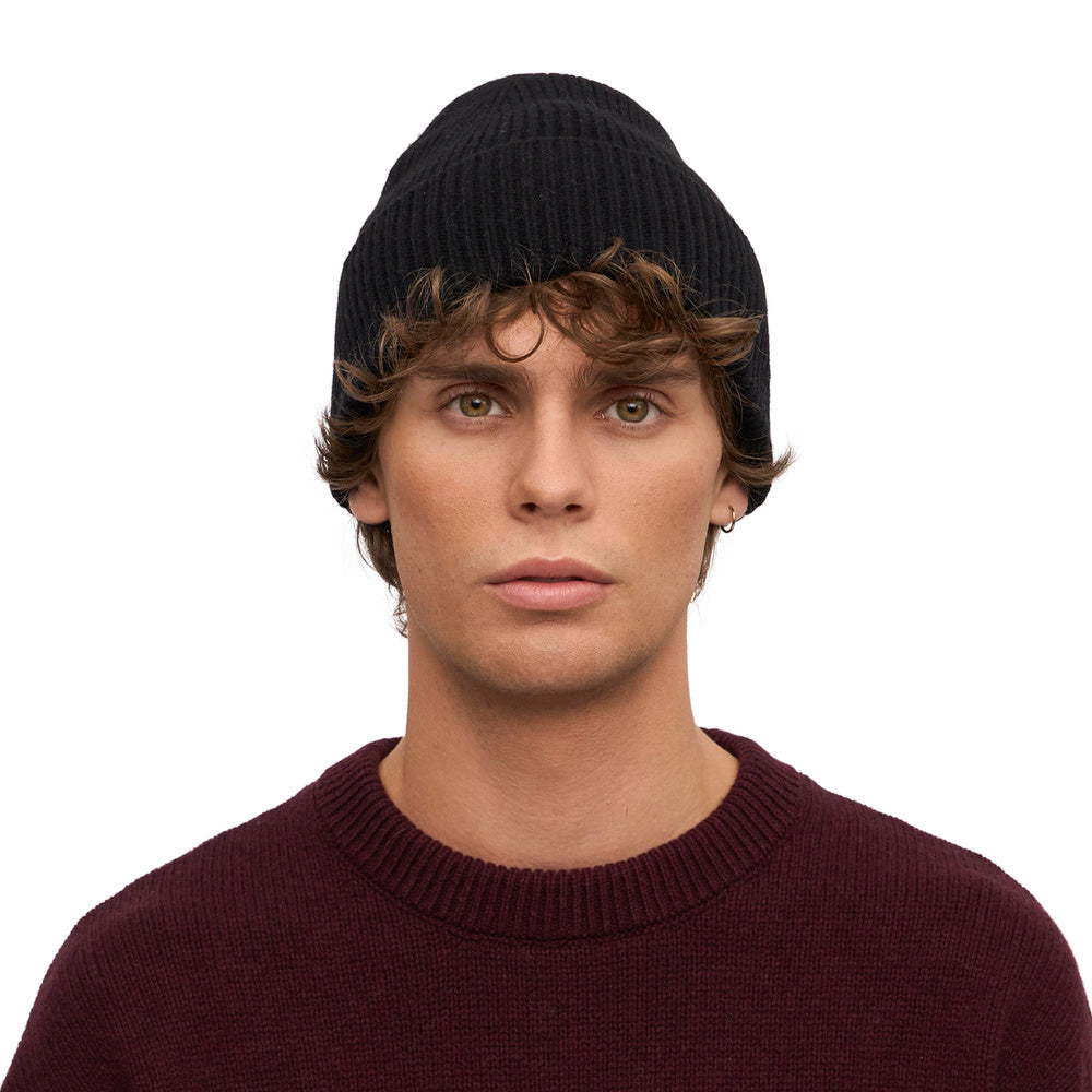Colorful Standard Merino Wool Beanie Deep Black – worn by a male model, front view