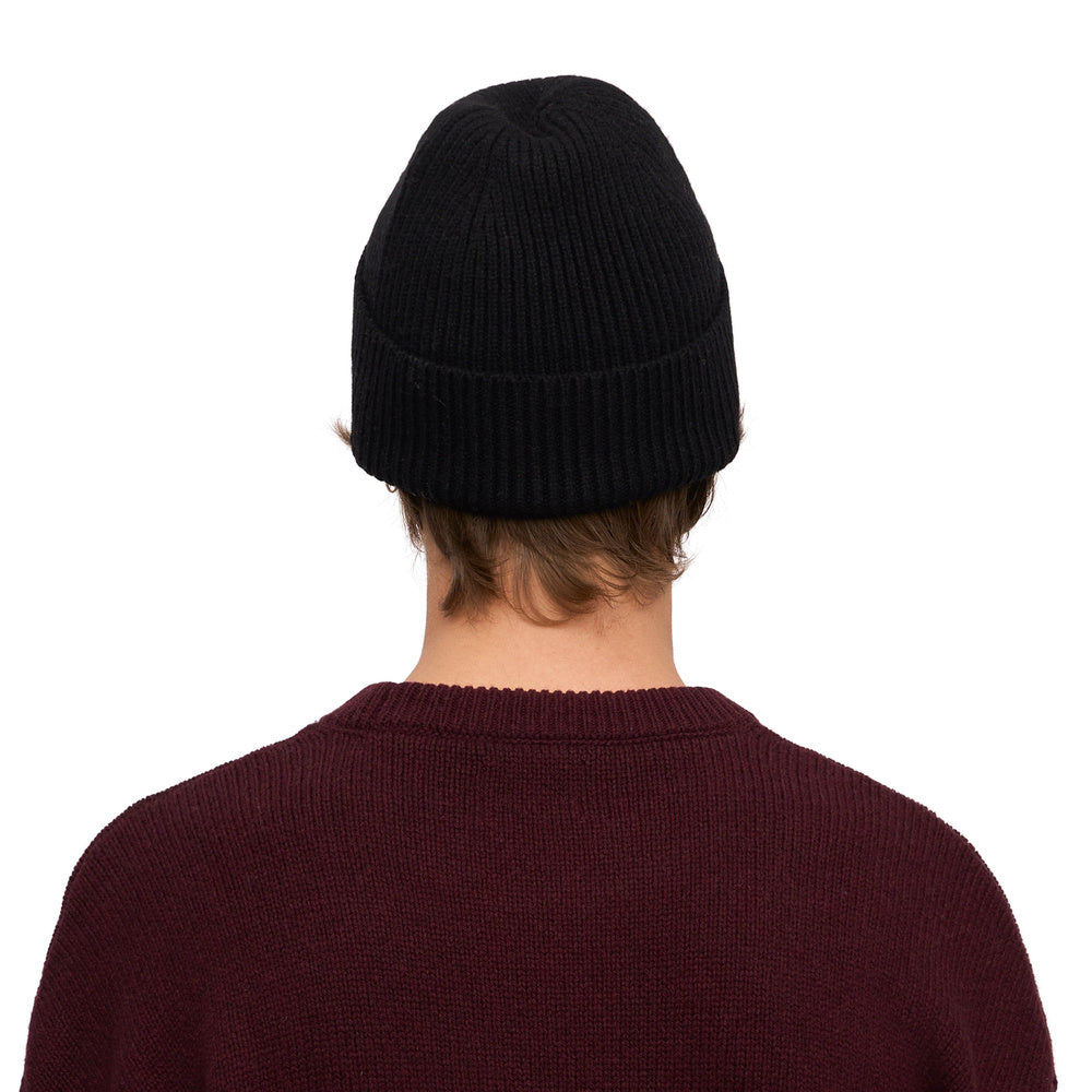Colorful Standard Merino Wool Beanie Deep Black – worn by a male model, back view