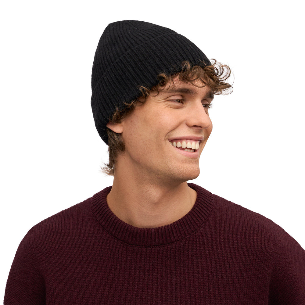 Colorful Standard Merino Wool Beanie Deep Black – worn by a male model, close-up