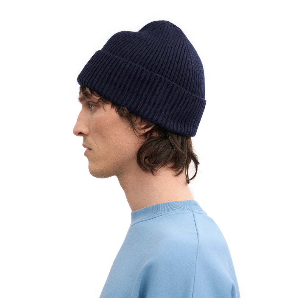 Colorful Standard Merino Wool Beanie Navy Blue – worn by a male model, side view