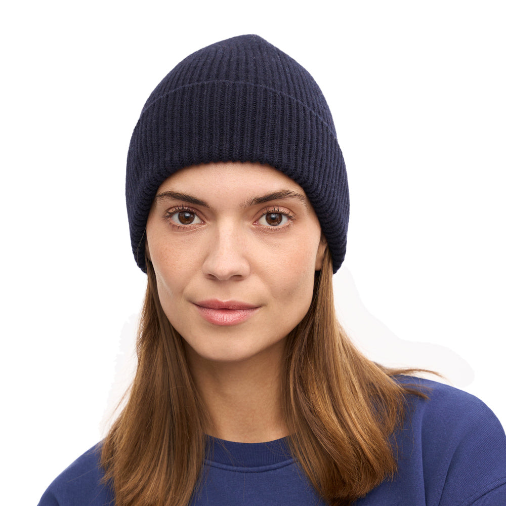 Colorful Standard Merino Wool Beanie Navy Blue – worn by a female model, front view