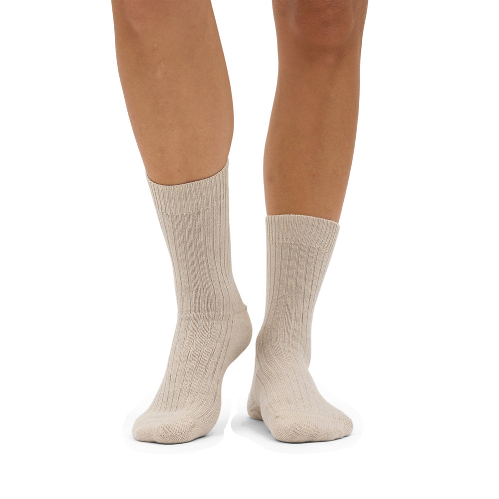 Calze Colorful Standard Merino Wool Blend Sock Ivory White – indossate da una modella, vista frontale