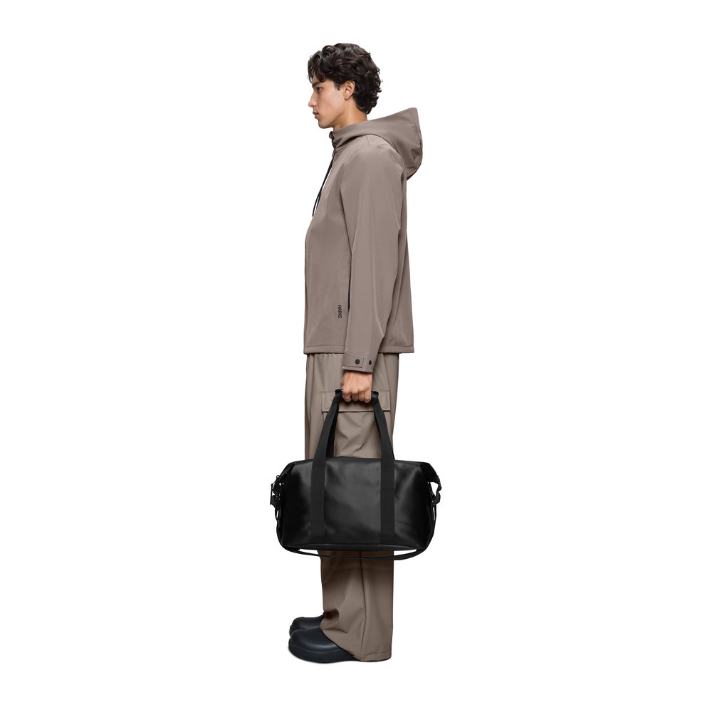 Rains Hilo Weekend Bag Small Black Satin – carried by a model